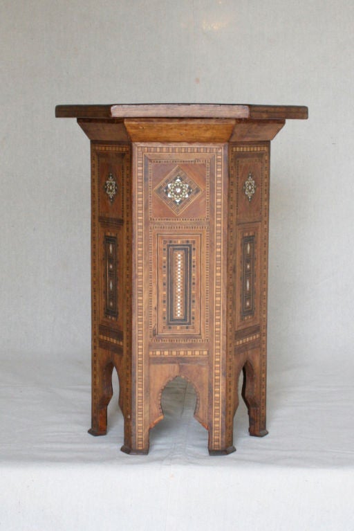 Hexagonal wood table with intricate inlays of mother-of-pearl, ebony and bone.