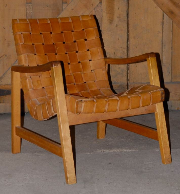 Leather and wood armchair, wooden frame, slightly curved arms, back and seat, removable seat, leather strapping, old repairs where arms join frame, attributed to Ernö Goldfinger, very comfortable