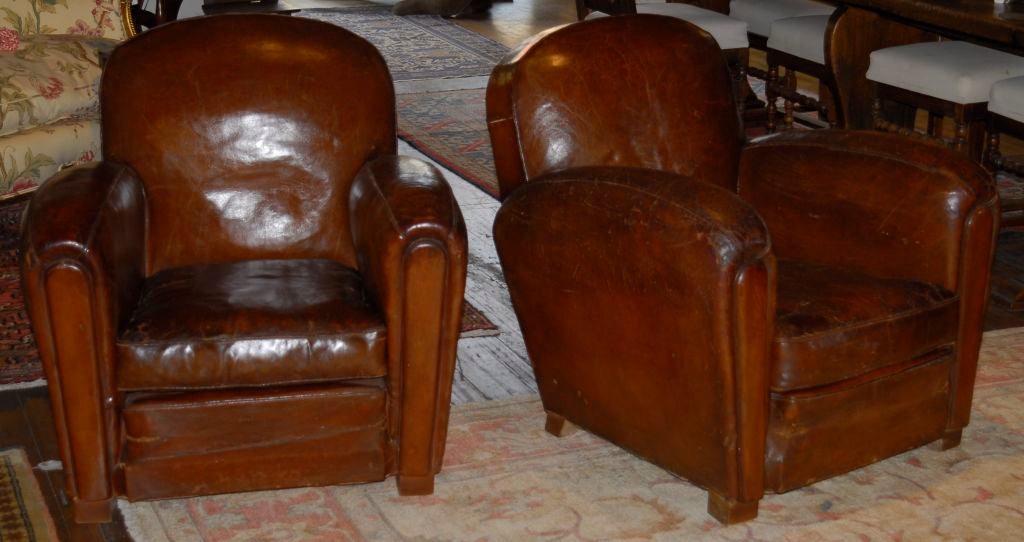 A pair of classic French Art Deco Leather clubs chairs with original leather seats