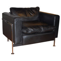 Black leather club chair designed by Robert Haussman