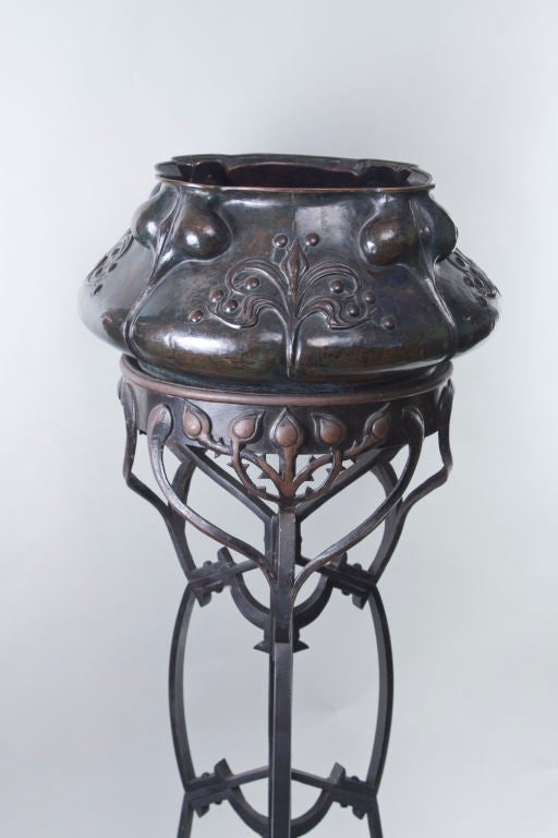 Austrian Art Nouveau patinated bronze & wrought iron plant stand decorated with highly stylized  heart and vine decoration on the stand and the planter with all over floral design. Unsigned