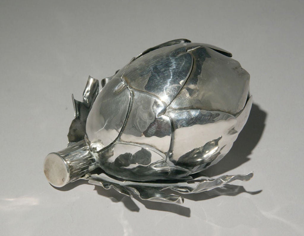 A sterling silver holder for a cigarette lighter in the shape of an artichoke by the American silversmith, William Spratling (1900-1967).  Hallmarked on the bottom with the Spratling hallmark and the Mexican government's<br />
eagle 63 mark