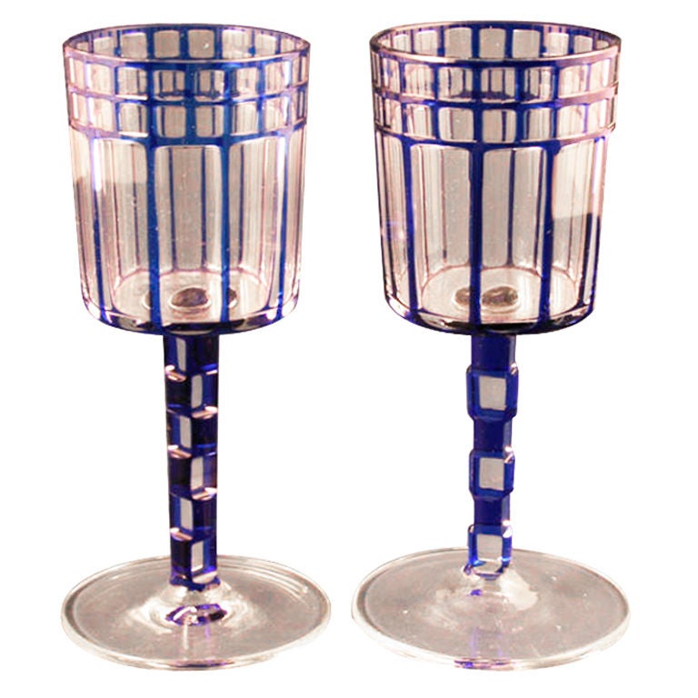 A pair of cobalt blue wine glasses with notched stems by Otto Prutscher who worked with the Wiener Werkstatte group. The glasses were manufactured by Myers-Neff for Prutscher in the period before World War I. The stem of one glass has a small nick.