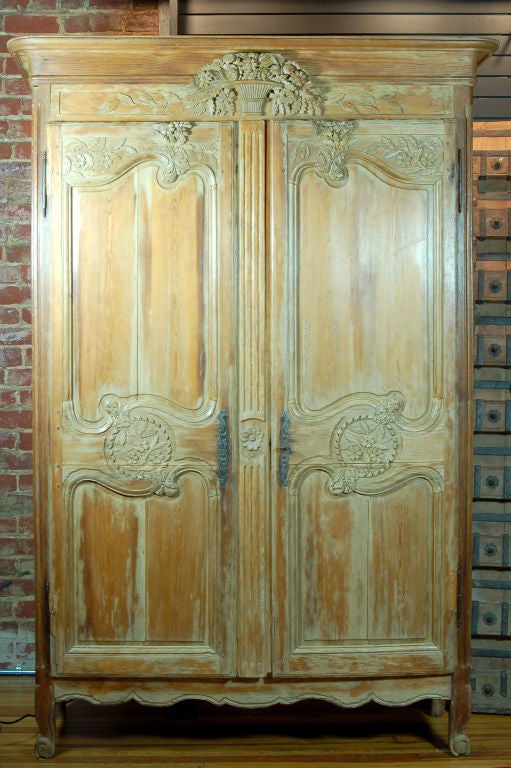 This wedding armoire is hand carved with detailing that reflects symbols of wealth and prosperity. Traditionally the armoire was hand built and carved by the father of the bride-to-be while she was still a young girl. This armoire was crafted during