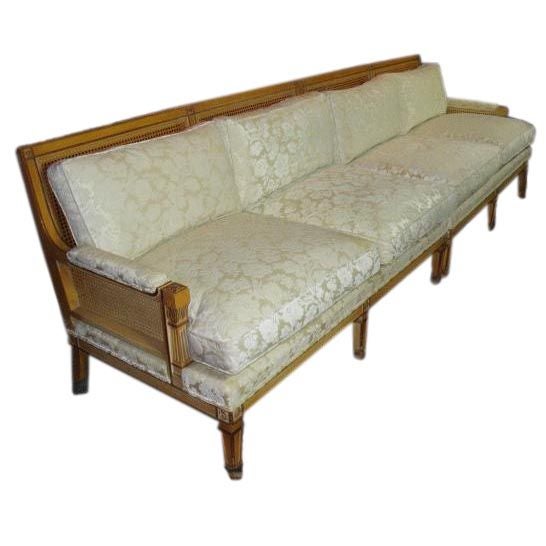 Beautiful Mid-Century two-piece sectional sofa, French style carved frame with square tapered legs and rosettes, striated cream and gold painted finish, cane backs and ivory colored cut velvet upholstery with double welt finish around the frame,