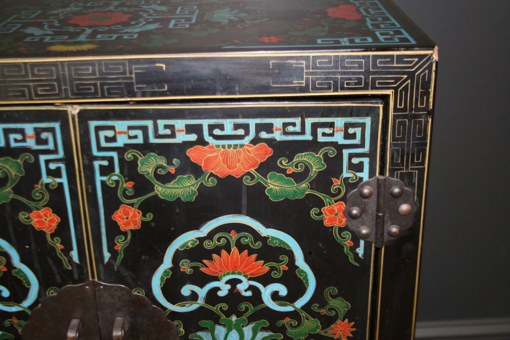Carved Japanese hardwood hand-painted cabinet with brass-plated hardware.