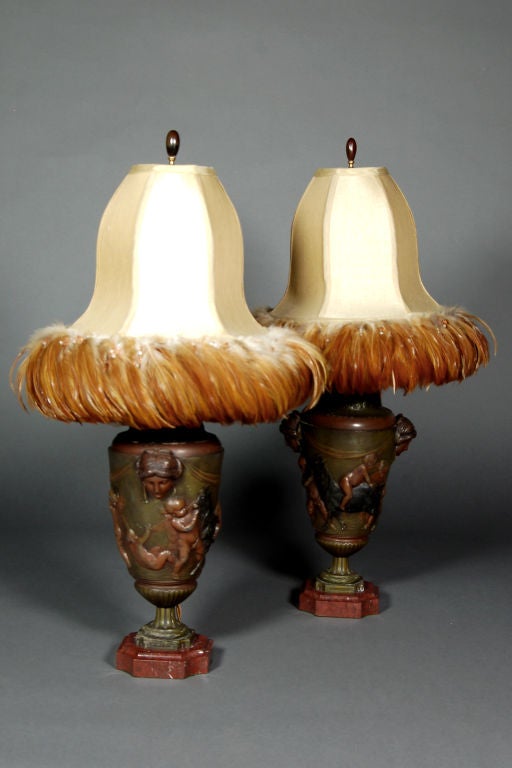 Pair of bronze and marble Art Deco lamps with cherub detail; silk, feathered, and beaded shades.