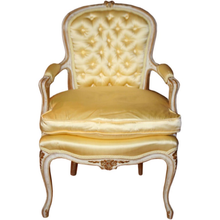 Beautiful yellow satin upholstery ladies parlor chair with golden rosettes delicately carved into wooden frame and cabriole legs.