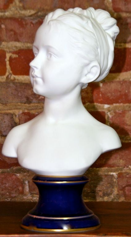 Gorgeous pair of porcelain busts of Louise and Alexandre Brongniart in bisque porcelain on royal blue enameled base, by Tharaud, Limoges, after the originals by Jean-Antoine Houdon (1741-1828). Louise and Alexandre were the children of the architect