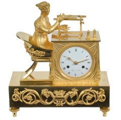 French Empire figural shelf clock with a maiden at a needlework.