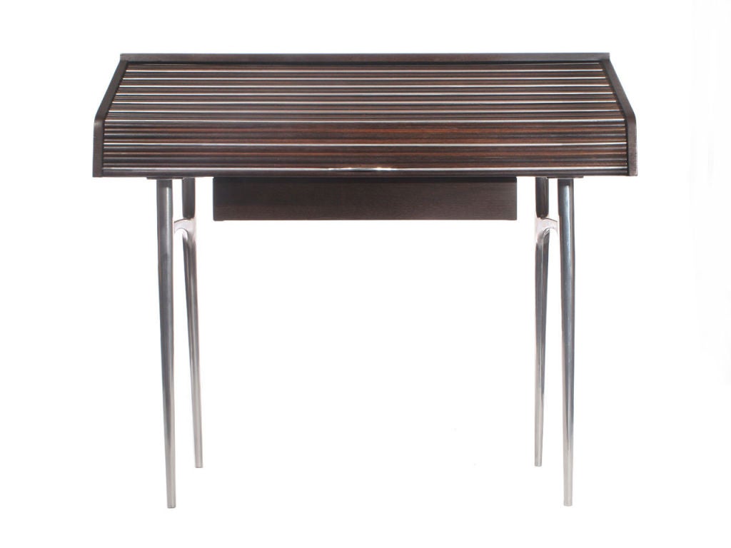 An unusual walnut roll-top desk with a extendable writing surface on tapered cast aluminum legs.