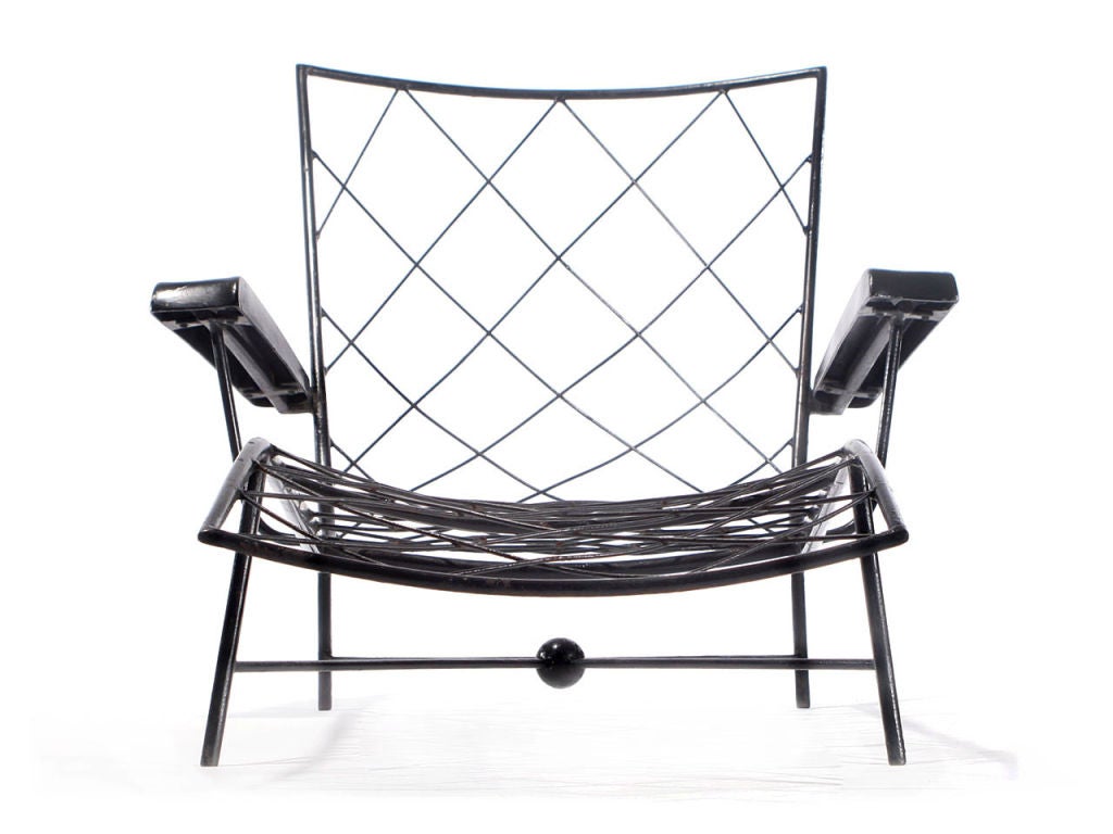 a pair of wire seated wrought iron chaise longue.