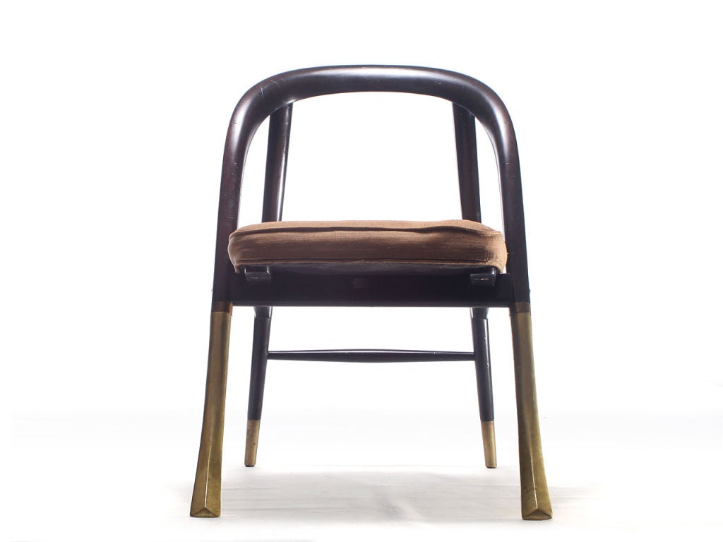 superb and rare chair by Edward Wormley for Dunbar. Walnut frame with solid brass front legs and upholstered seat.