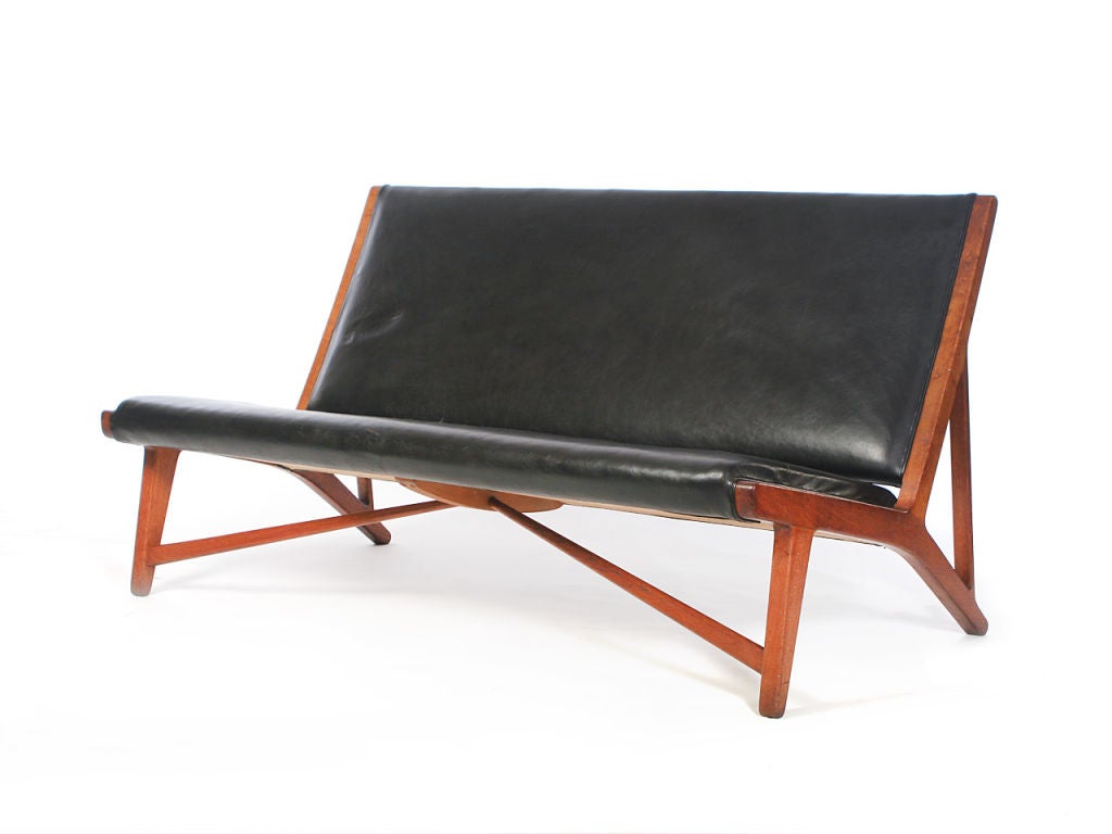 an upholstered oak framed sofa/bench/settee in original black oxhide. Designed by Hans Wegner Cabinetmaker Johannes Hansen