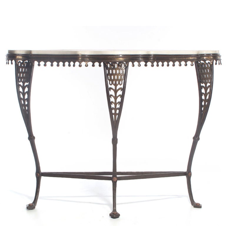 A bronze and wrought-iron console, with the original white and amber marble top, on three cabriole legs. Designed and crafted by Oscar Bach