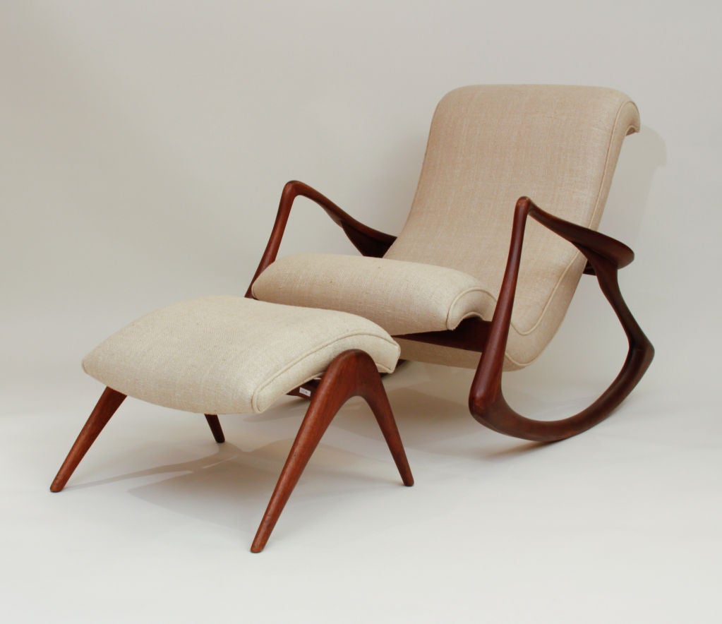 Vladimir Kagan contour rocker and ottoman, both with sculpted walnut frames and beige fabric uphostery.