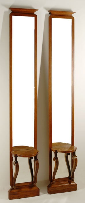 A pair of unusual Asian inspired tall and narrow Art Deco mirror consoles.