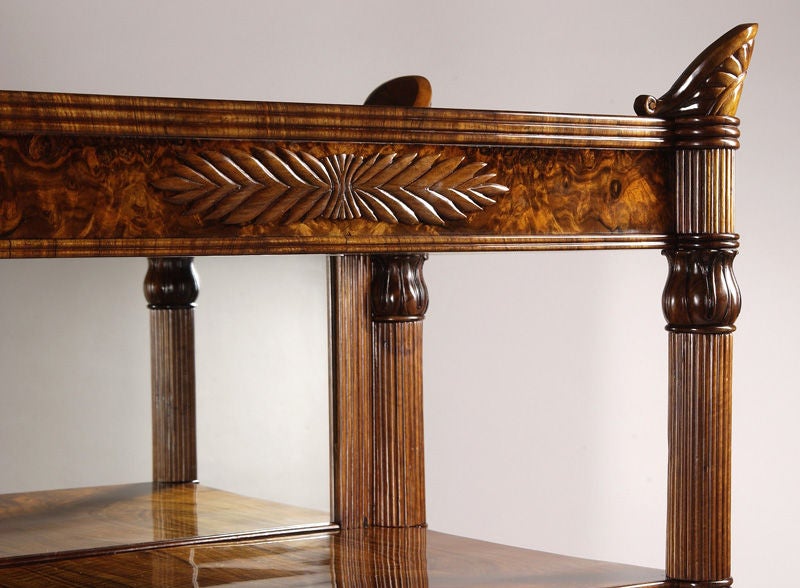 Walnut veneer with carved acanthus motif and mirrored back.