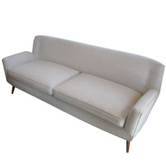 A sofa in the style of Jens Risom