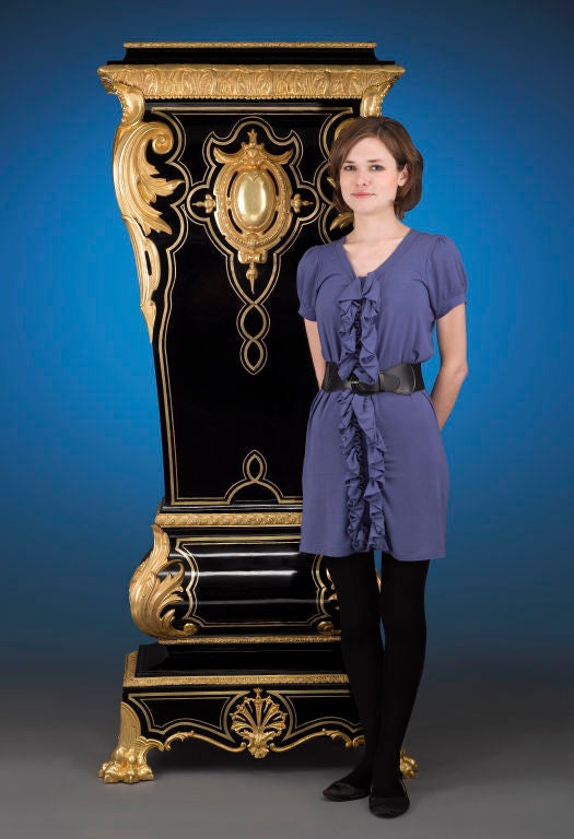 Tremendous size and exquisite ormolu detailing distinguish this important 19th-century French pedestal. Crafted of ebony and ebonized woods, this outstanding fixture boasts intricate brass inlay and bold ormolu of exceptional quality on all four