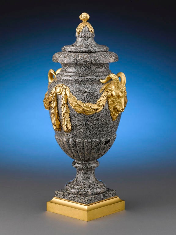 The Neoclassical form of these rare and important set of Henri Dasson urns, crafted of striking gray marble, are beautifully complemented by exquisite doré mounts. Skillfully executed and artistic doré mounts are hallmarks of Dasson's work, and
