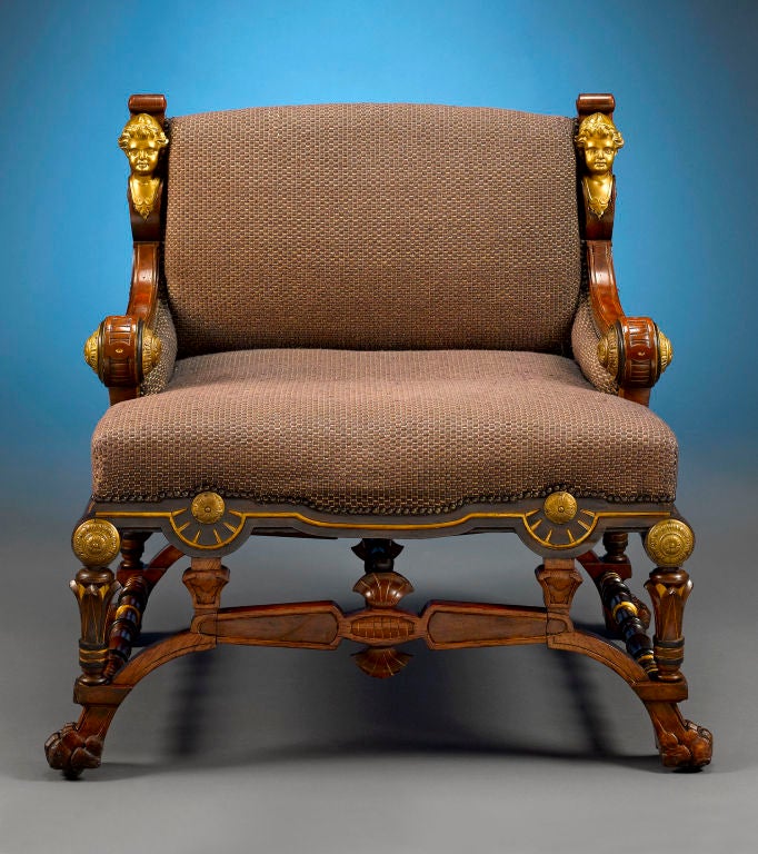 This majestic pair of slipper chairs came from the Pierre Bergé New York collection. Crafted of walnut by the respected American firm of Pottier & Stymus, these chairs exhibit the striking American Renaissance style. The characteristic boldness of