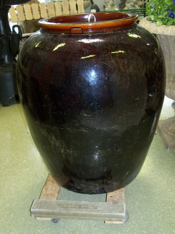 Rice Wine Jar that originated in China and purchased by a plantation owner in Malaysia in the 19th Century.  Then, via collectors, it found its way to the Welsh countryside.  Distillery Stamp clearly visible on the surface.