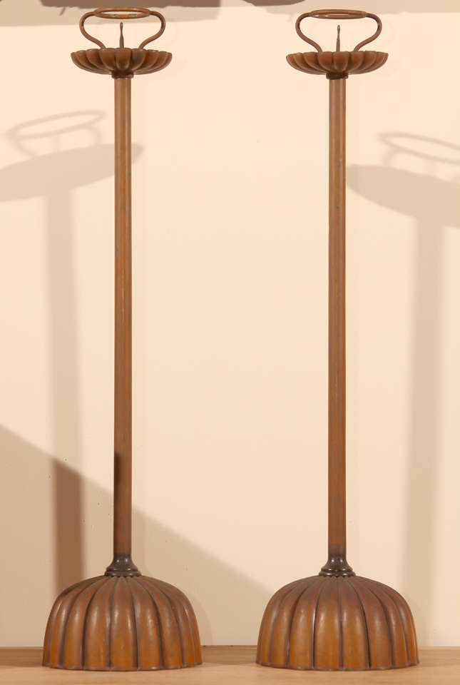 A pair of Japanese bronze candlesticks (shokudai). The well proportioned candlesticks with chrysanthemum-shaped domed bases supporting tall shafts and ending in chrysanthemum bobèche with picket and ring shaped candle guard.
Meiji Period