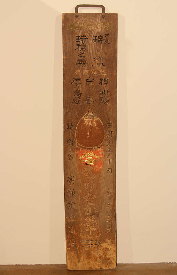 A Japanese shop sign, kanban, for a brush store. The keyaki (zelkova) wood sign with a shallow carving of a standing brush. The brush has traditionally been considered one of the artist's four treasures, along with ink, inkstone and paper. The