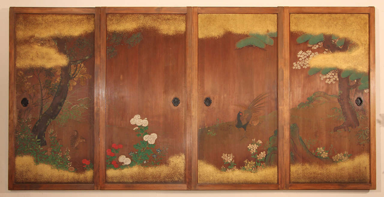 A set of four Japanese painted {sugi} (cryptomeria) wood doors depicting a {kacho}, or bird and flower, scene.  The left two doors depicting three quail sheltered amongst chrysanthemum ({kiku}) and autumn grasses ({aki no nanakusa}), including