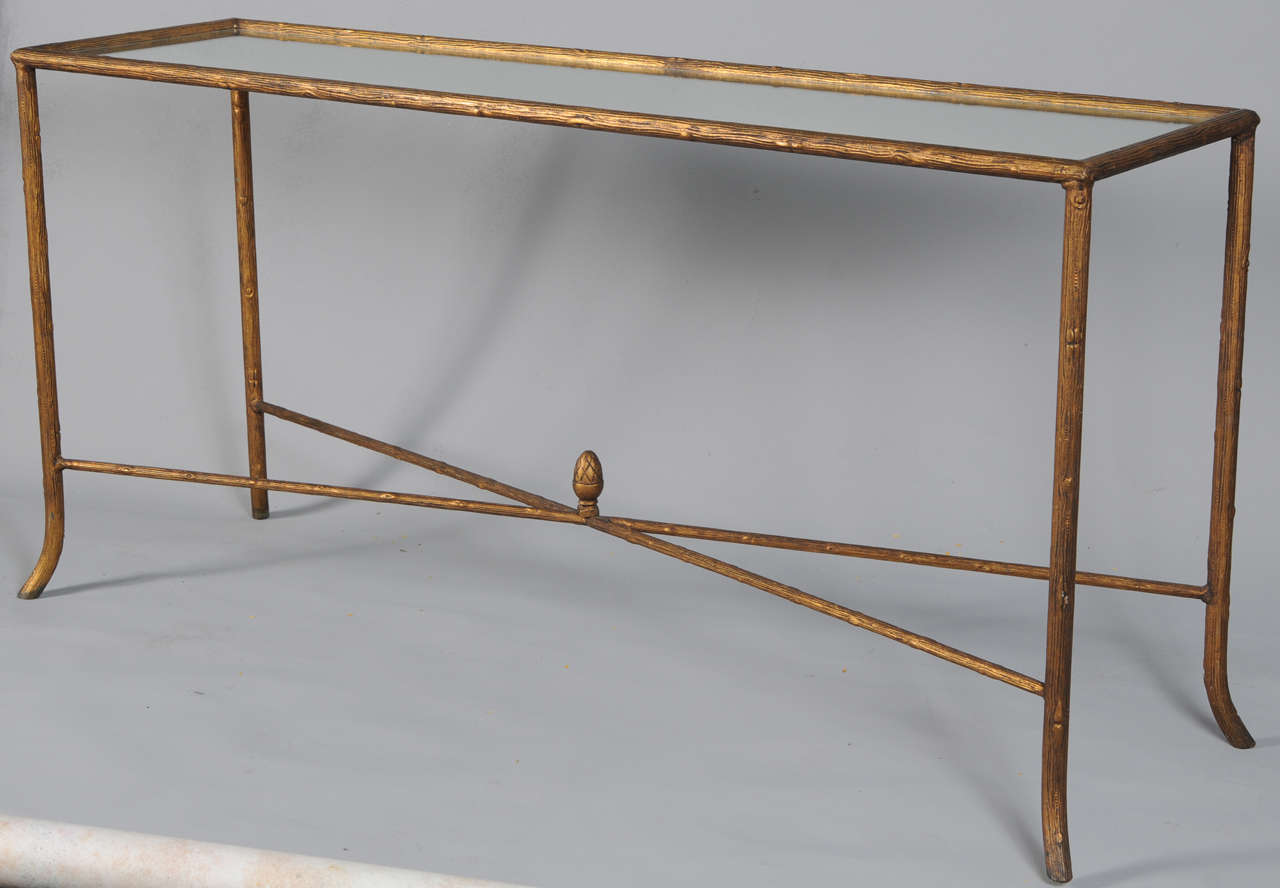 Narrow console, of forged steel with leaf finish, having a rectangular top of mirror, its frame formed as branches with wood-grain details, legs joined by X-stretcher centered with an acorn, splayed feet.

Stock ID: D6518

(Keywords: Sofa, Boix,