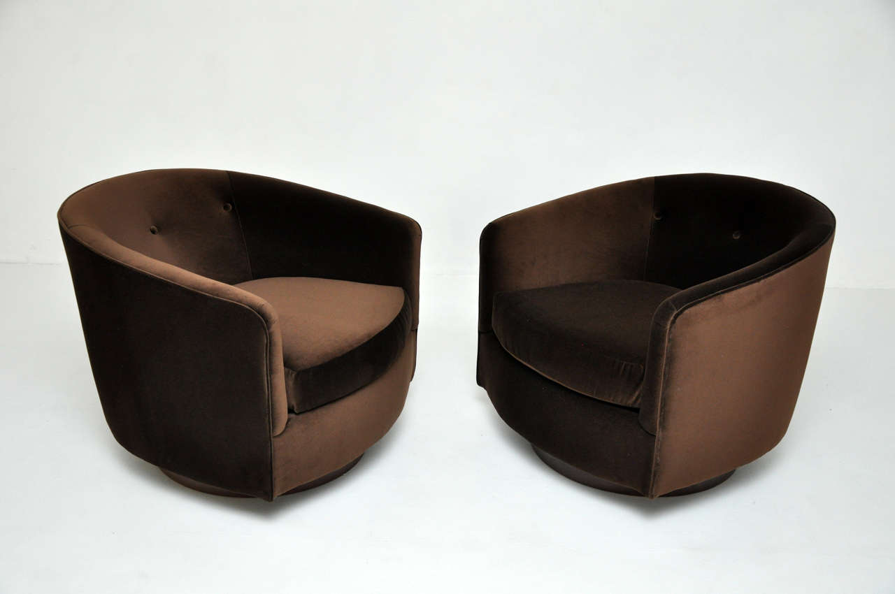 Pair swivel lounge chairs by Milo Baughman for Thayer-Coggin.  Newly upholstered in chocolate velvet.  Walnut bases have been fully restored.