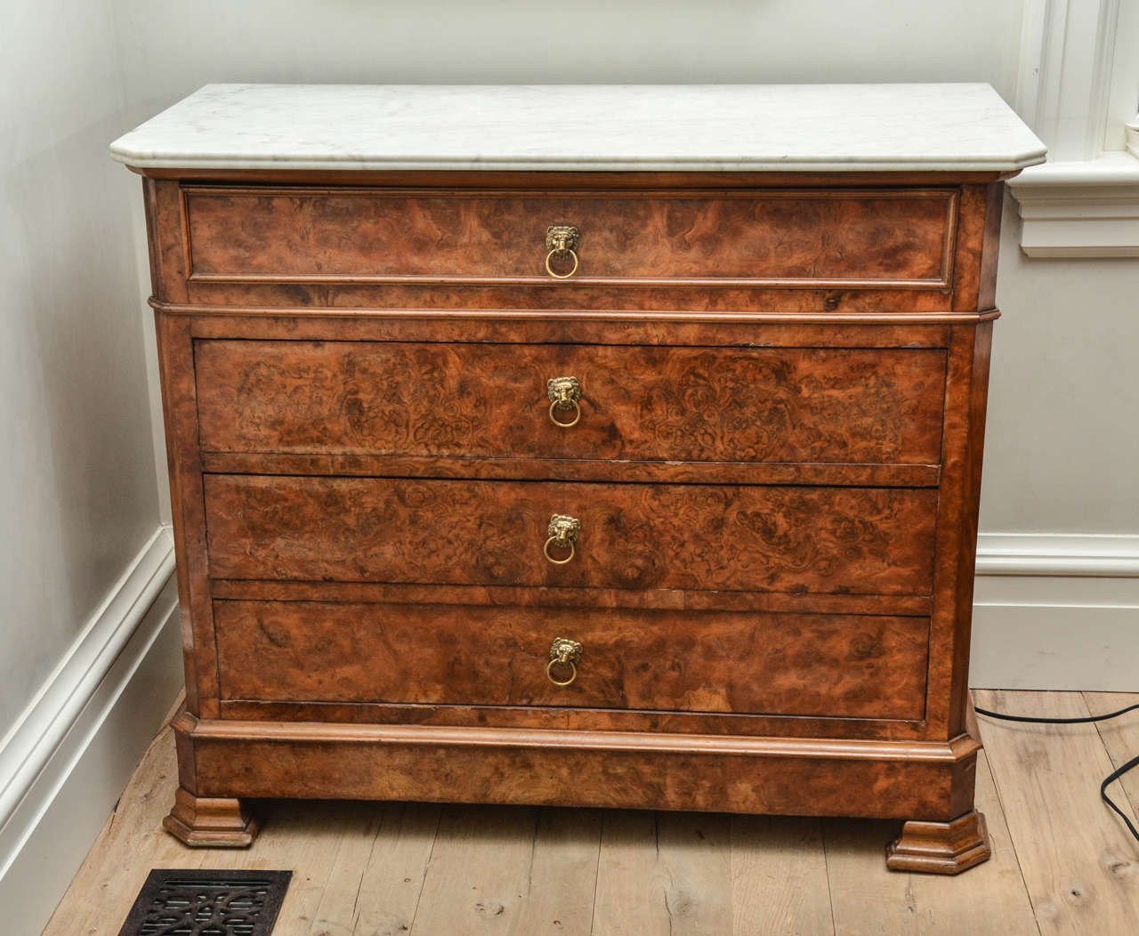 Stunning 19th century Louis Philippe commode in walnut with brass lion pulls and original white marble top.