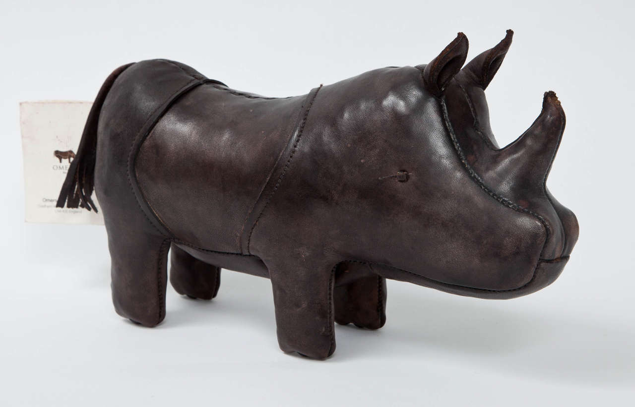 Rhinoceros made of burnished brown leather by Dimitri Omersa. England, circa 1960. Rare, smaller desktop version of the signature animal-themed ottomans popularized by and sold in the early Abercrombie & Fitch and Liberty of London stores (12 inches