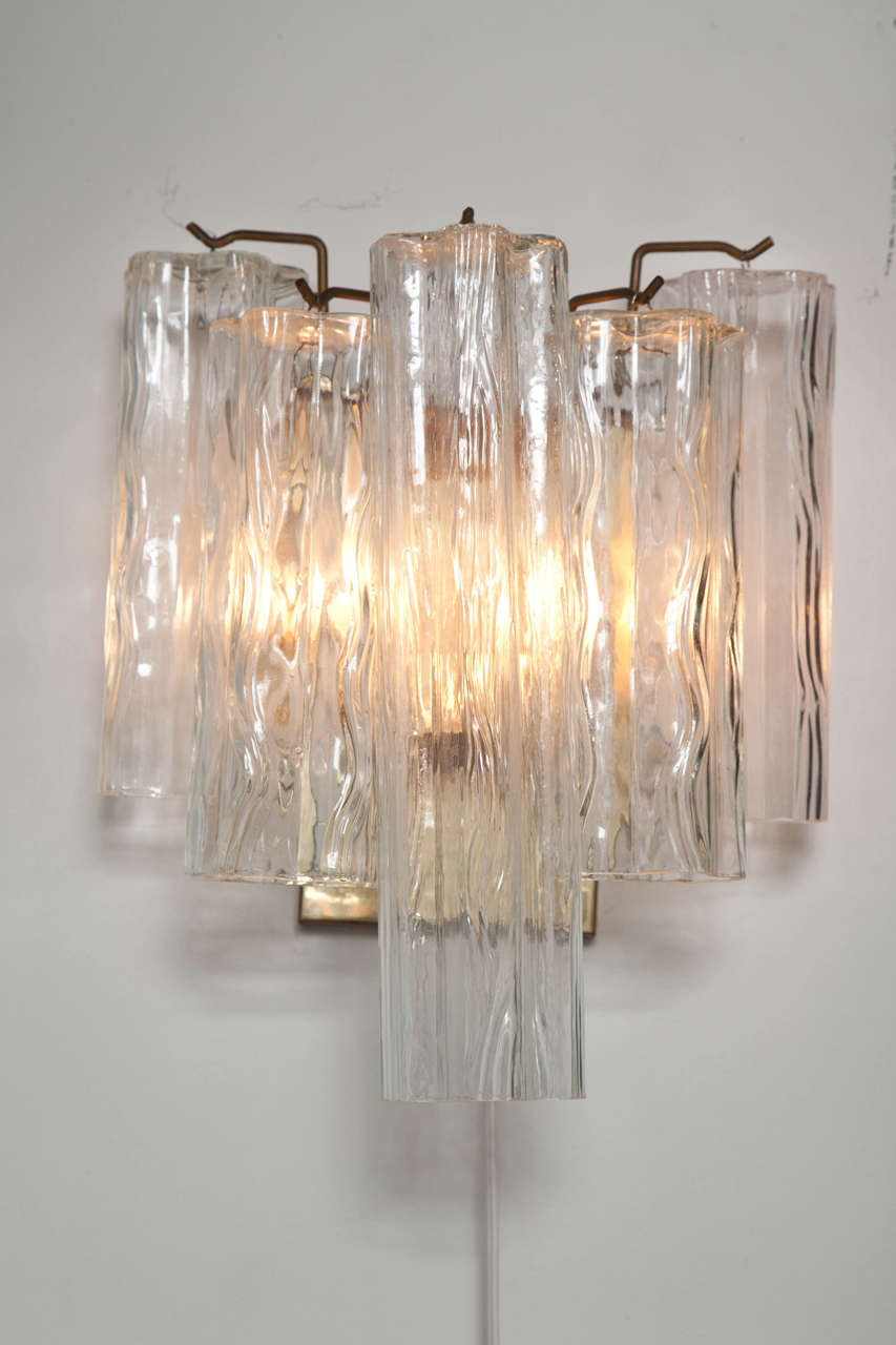 Pair of Venini sconces.  Italy, circa 1960.  Each sconces features five (5) signature tronchi tubular textured glass pendants suspended from a polished brass backplate.  Unsigned.

Dimensions:
12.5 inch height
11 inch width
7.25 inch
