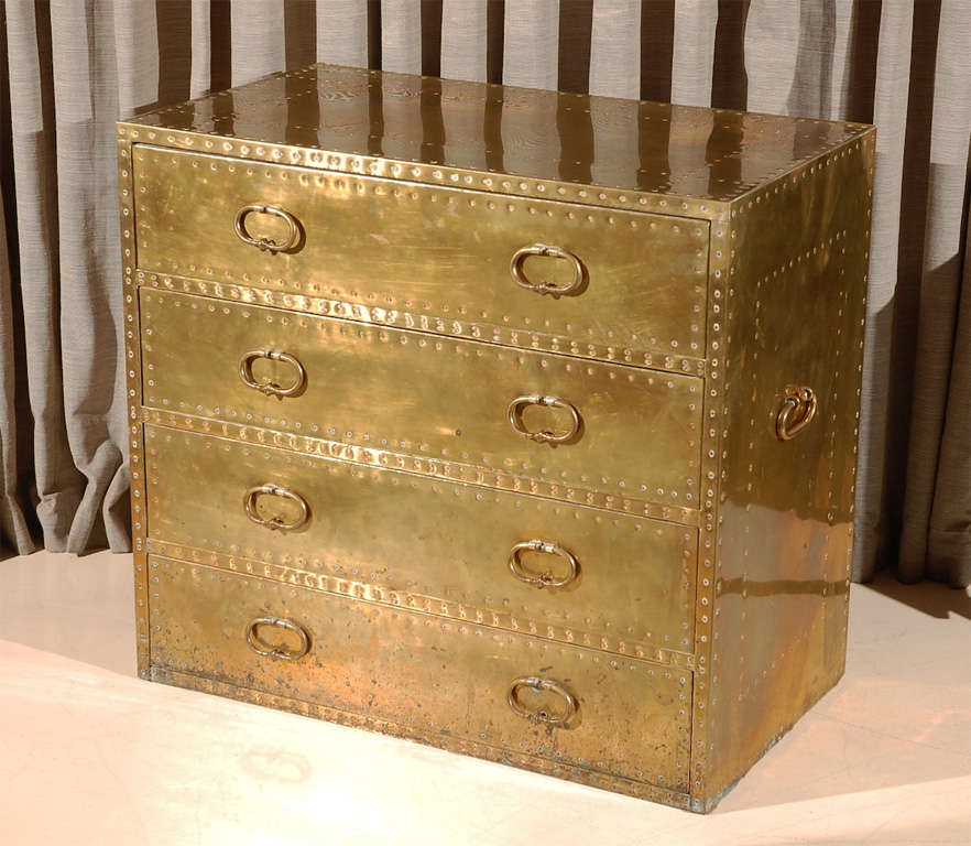 Four drawer brass dresser with solid brass hardware.