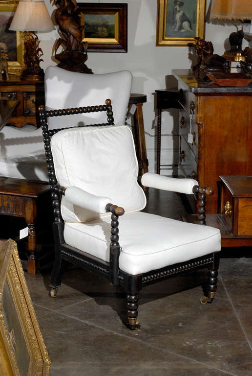 19 th.c. English bobbin chair with new muslin upholstery and castors on feet.