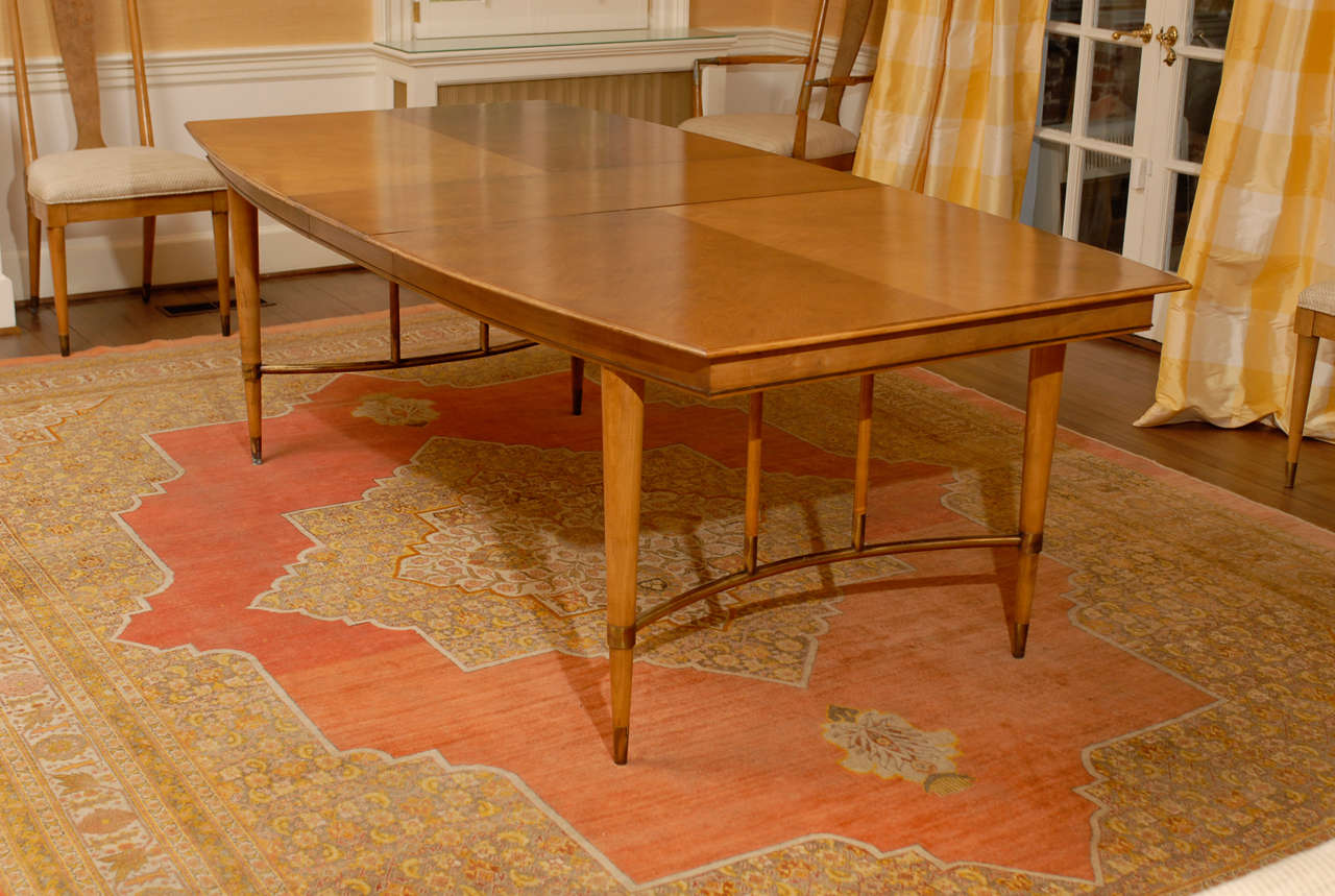 Beautiful dining table by Bert England for Johnson Furniture Company. Weathered cherry with brass accents, wonderful patina. The table comes with three (3) leaves, circa 1959. Measurements noted are for the table, minus leaves. Each leaf is 15
