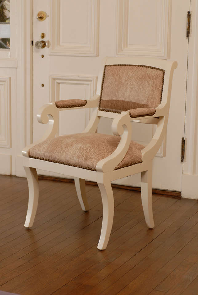 Stunning, modern Regency armchairs in the style of Karl Springer. Restored in cream lacquer, cork fabric with distressed nail head detail. Total of four (4) are available. The price noted is for a pair.TOM ROBINSON MODERN at TRAVIS & COMPANY