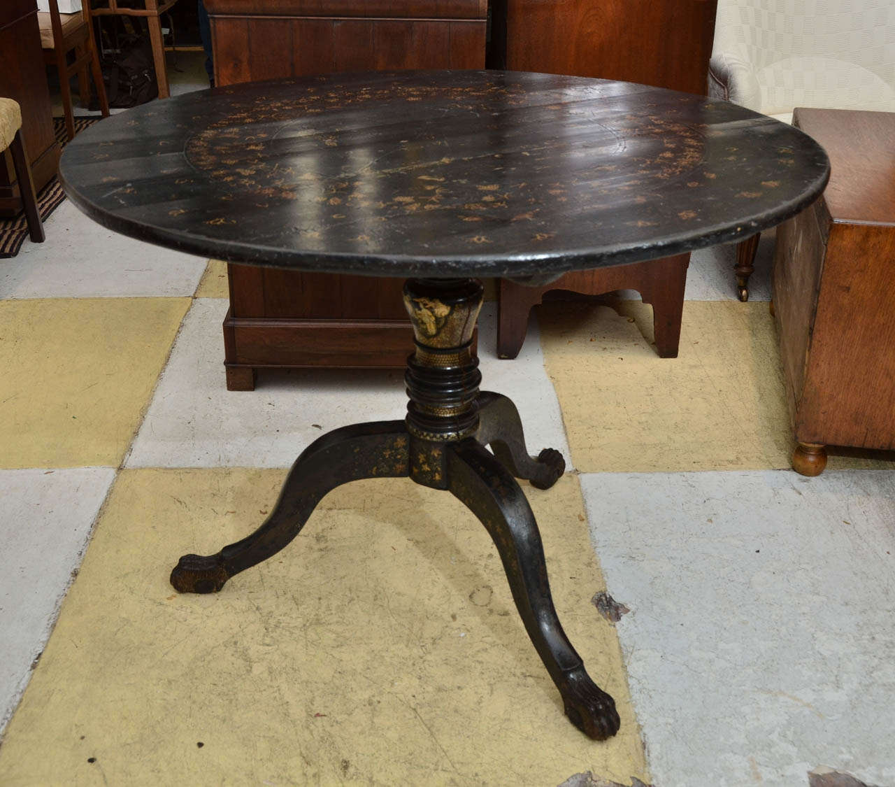 Black Lacquer China Trade Tilt Top Breakfast Or Center Table. The Top Has Traces Of Circular Foliate Gilt Decoration Centered By Temple Scene. The Center Baluster Base Has Scenes With Oriental Female Figures. The Table has Three Cabriole Legs With
