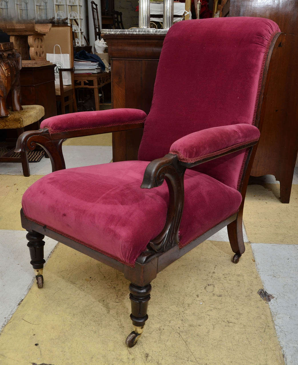 English mahogany framed open armchair with leaf scroll carved arm supports with upholstered arm rests. Front legs with upturned lappet carving. Front legs with cup castors signed Cope & Collinson Patent.  Late Regency early William IV, 1830-40.