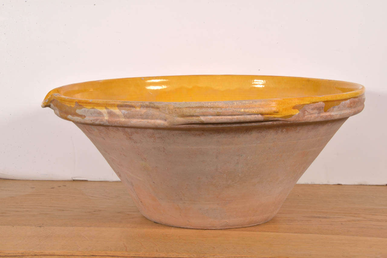 Antique French Terracotta mixing bowl, from Provence. The lovely mustard glazing on this earthenware is sure to add warmth and charm in your kitchen! (For decorative use only.)