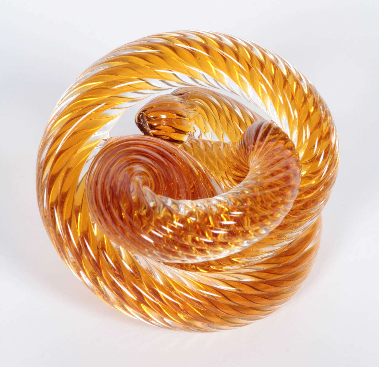Tangerine-colored Murano glass coiled paperweight or small tabletop sculpture, Italy, circa 1970.