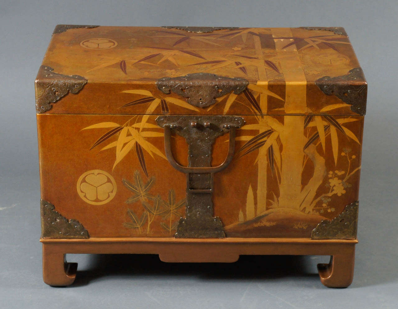 Japanese fabric storage box, second half of the 19th century, pine, plum and bamboo design, (three friends of winter) with beautifully executed multiple tones of gold, with gilded bronze mounts.
Box on removable stand.  
Overall measurements, box