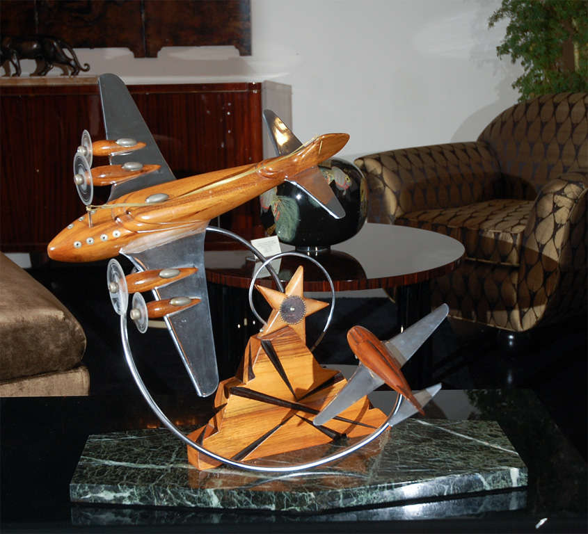 Authentic Art Deco airplane sculpture featuring the heavy bomber “Boeing B-17 Flying Fortress” in air battle with the P1 Mustang. Original wood and metal components with green marble base. 