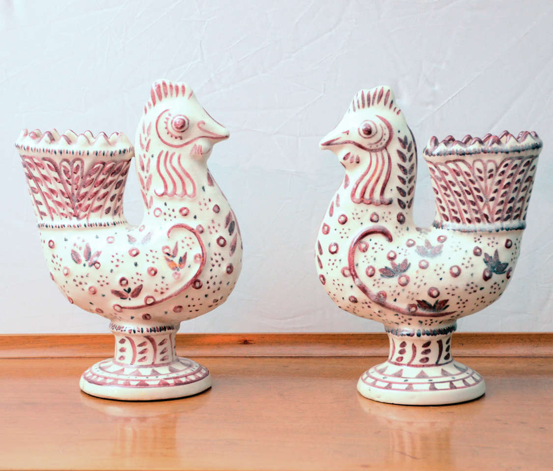 Whimsical vases or garniture in the form of roosters, cream glaze with raised and rose-glazed ornament. Carl Walters received a Guggenheim to study and pursue ceramic glazes. He excelled in the creation of stylish birds and animals. Signed on base