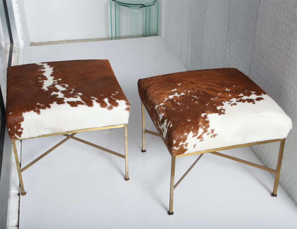 Pair of Paul McCobb stools with cow hide upholstery.
 with new cow hide upholstery.