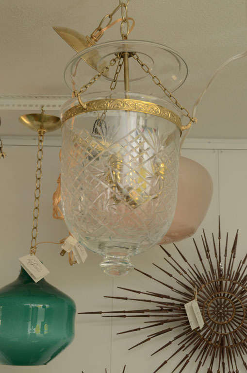 Etched bell jar pendent trimmed with brass.  Center arm accommodates 3 lights..