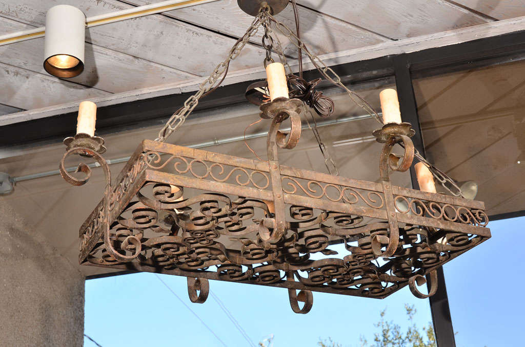 This incredible 19th century, French hand-forged iron chandelier is sure to add warmth to any room in your home! Perfect above a dining table, kitchen island or even in a bedroom or den. Hard wired for electricity.