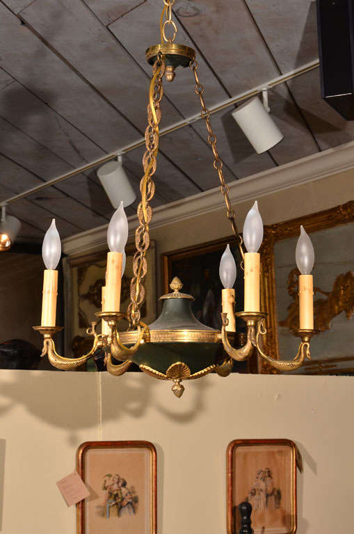 This lovely chandelier has whimsical etching in all of the brass. Elegantly perched swans make the arms of the piece. The finials have an acorn detailing on them, along with leaf motifs. Even the chains and banding on the top and bottom have a